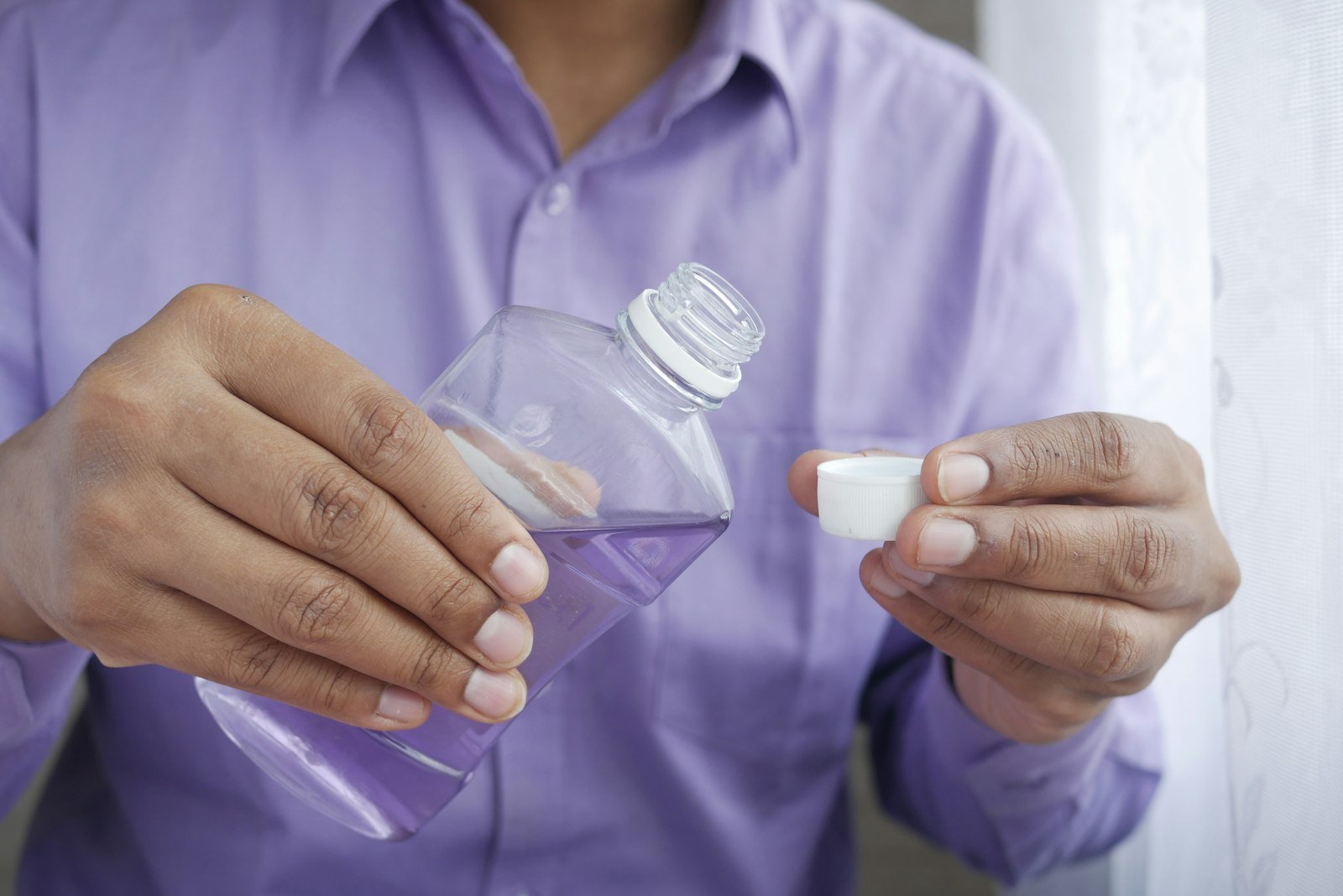 Mouthwash bottle and probiotic supplements side by side